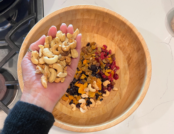 granola in a bowl hand mixing